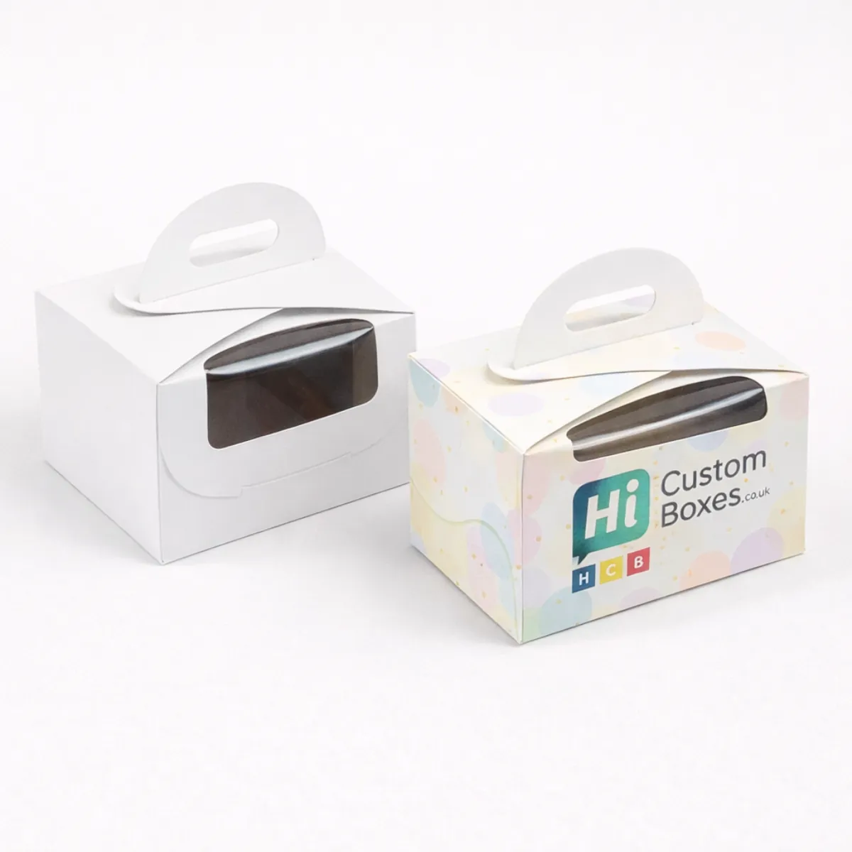 Two small white gabled boxes with windows and handles- one plain and one branded pastel- class=
